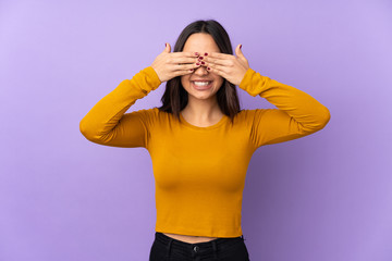 Young mixed race woman isolated on purple background covering eyes by hands