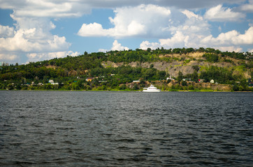 River boat on a background of a green mountain