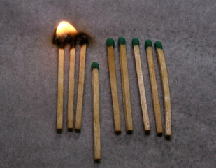 Burning match setting fire to its neighbors, a metaphor for ideas and inspiration