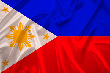 silk national flag of the modern state of the philippines with beautiful folds flutters in the wind, concept of tourism, travel, emigration, global business