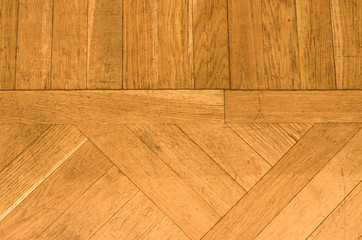 Wooden flooring is light brown. Parquet board laid diagonally