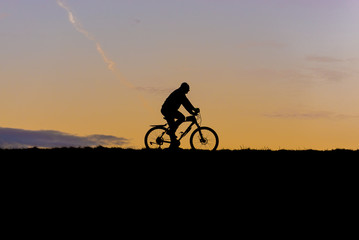 Obraz premium Man rides bike on a Vistula River stopbank in Warsaw, Poland