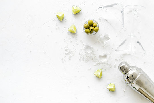 Cocktail Concept. Martini Glasses And Shaker - Near Lemon, Olives, Ice - On White Background Top-down Copy Space