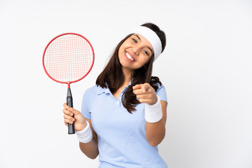 Young badminton player woman over isolated white background points finger at you while smiling