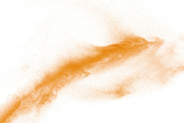 Plakat Orange powder dust particles explosion on white background.Orange dust particles splash.