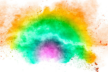 Abstract multi color powder explosion on white background.Freeze motion of dust particles splash.