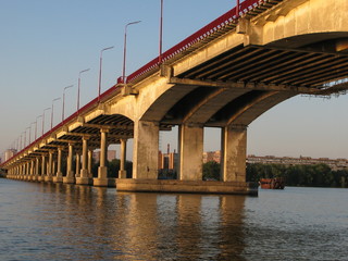 panoramic view of the city and the bridge across the Dnipro River, lit by the setting sun, Dnipro city, Ukraine
