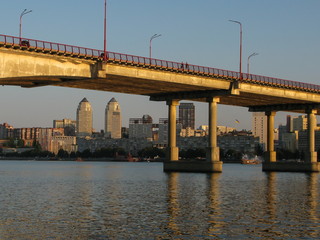 panoramic view of the city and the bridge across the Dnipro River, lit by the setting sun, Dnipro city, Ukraine