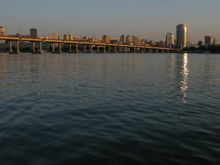 panoramic view of the city and the bridge across the Dnipro River, lit by the setting sun, Dnipro city, Ukraine