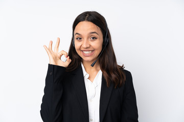Young telemarketer woman isolated on white background showing ok sign with fingers