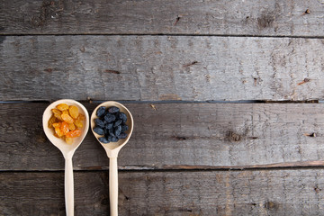 Raisins in a wooden spoon. Rustic style.