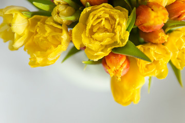 Bouquet of yellow and red tulips on a white background.