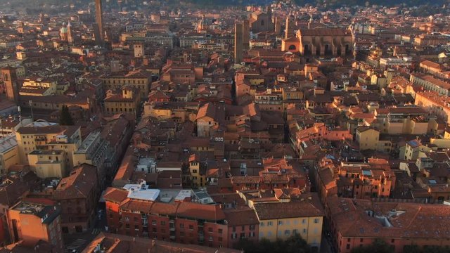 aerial view of bologna city center at sunrise tilt up drone flying over old town revealing shot