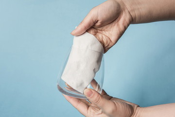 One hand is testing the tenacity of a tissue