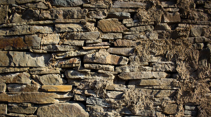 old masonry made of flat stone and clay