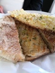 Tasty garlic bread slices with fresh herbs in a restaurant in Madeira, Portugal