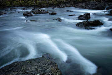Long exposure shot of the waterfalls in Glen Orchy near Bridge of Orchy in the Argyll region of the highlands of Scotland during winter whilst the river is flowing fast from rainfall