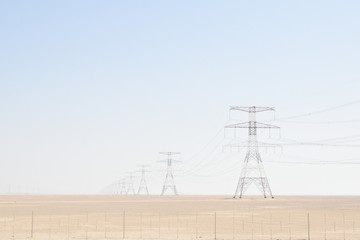 Electric post is used to support high voltage powerhead lines.Electric tower in  Desert.Day time photography at Liwa,Abu Dhabi