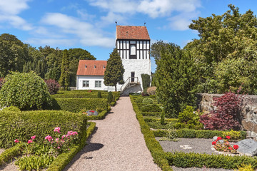 Fototapeta na wymiar Belfry by the Ny Kirke (New Church) located in Nyker village, Bornholn island, Denmark.