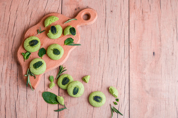 Shortbread cookies with mint, fragrant mint and sprigs of demen sedated on a wooden background.