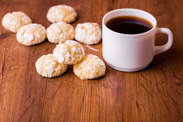 Shortbread orange biscuits with sprigs of semarin, with fresh orange and juice on the table.