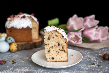 Easter composition with sweet bread, kulich and eggs on light background.