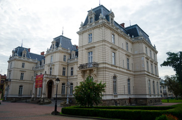 Fototapeta premium The Palace of Count Potocki in Lviv. An old mansion with a lawn. The palace in the style of French classicism. Medieval Europe. Lviv, Ukraine, July 18, 2017
