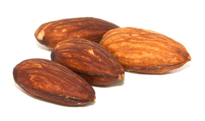 Group of almonds with leaves isolated on white background