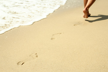 footprints in the sand on the beach