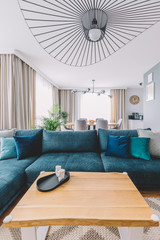 Open space living room with a big couch in a modern apartment. Interior design