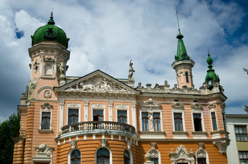 Obraz premium Beautiful palace in Lviv, Ukraine. Building in 1910 donated to Lvov by Metropolitan Andrej Sheptitsky for National Museum. Red mansion with green spiers and towers and decorative stucco.