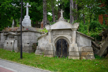 Fototapeta premium Lychakiv memorial cemetery in Lviv. An ancient Lutheran cemetery with statues and Gothic architecture. Lyubov, Ukraine, July 19, 2018