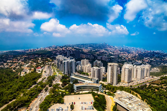 Panoramic view of Haifa - bay, downtown, residential and university buildings in a sunny summer day from Eshkol Tower, the highest point of Haifa University on the Mount Carmel, Israel