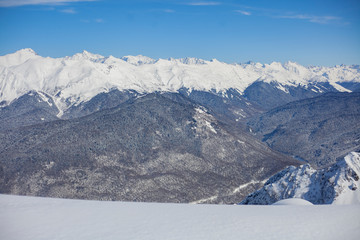 Mountain landscape with snow. Snow-capped peaks of the mountains. High altitude. Background of calm mountains. Sunny weather in the highlands.