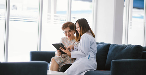 Young doctor consulting senior patient at health care clinic 