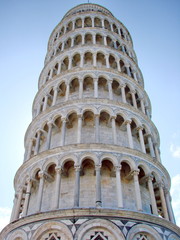 Bottom view of the architectural beauty of the falling tower in the sunshine aura.