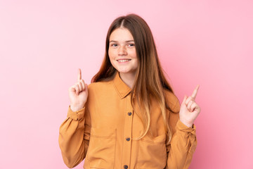 Ukrainian teenager girl over isolated pink background pointing up a great idea