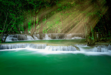 Beautiful waterfall with sunlight in autumn forest at Erawan National Park, Thailand, Nature landscape , Beautiful steam green forest nature