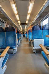 Interior of a passenger train with empty seats