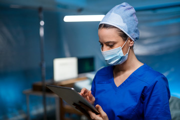 Doctor holding tablet in hospital, coronavirus concept.