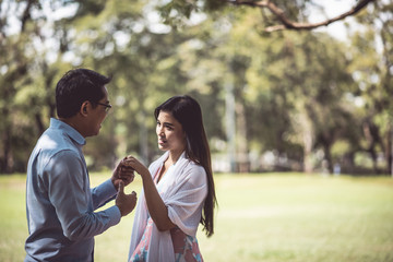 Fototapeta premium Romantic Couple Standing On Field At Park