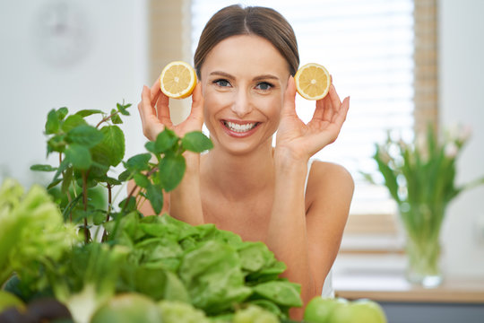 Healthy Adult Woman With Green Food In The Kitchen