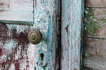Old vintage door handles. Rusty metal locks and latches. Protective devices for wooden yard gates