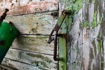 Old vintage door handles. Rusty metal locks and latches. Protective devices for wooden yard gates