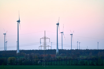 Wind turbines on countryside wind park at sunset