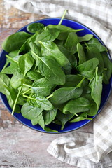 Fresh baby spinach leaves on a plate.