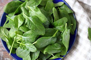 Fresh baby spinach leaves on a plate.