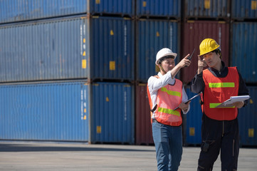 Foreman control loading containers box from cargo freight ship for import export, Foreman control industrial container cargo freight ship, Business import and export logistic concept.