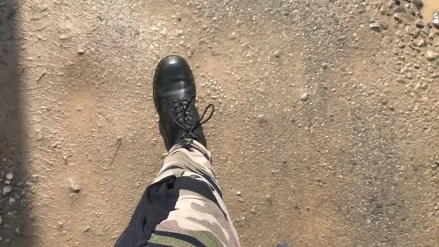 Man in camouflage pants walking