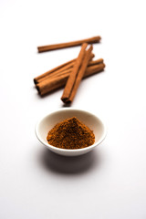 Powder cinnamon and sticks also known as Dalchini or Dalcheenee masala from India, selective focus